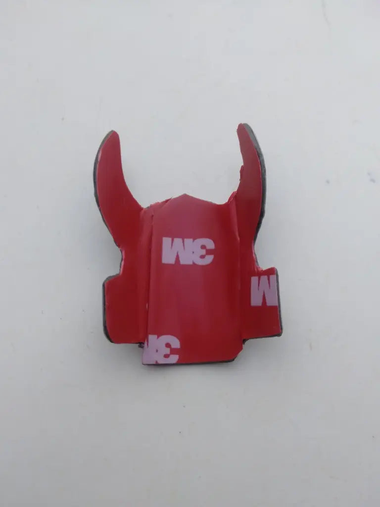 Rear view showing the pre-applied double-sided adhesive tape on the Iceland bike badge.