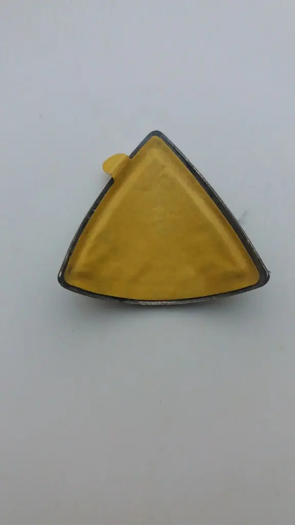 Rear view showing the pre-applied double-sided adhesive tape on the NOS Marin aluminum badge.