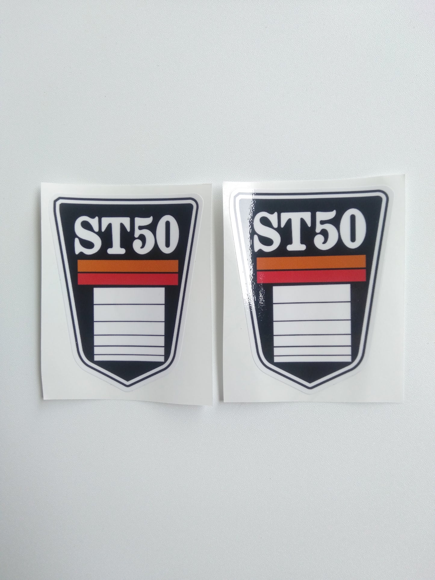 Two 'ST50' stickers with a red and orange stripe on a white background