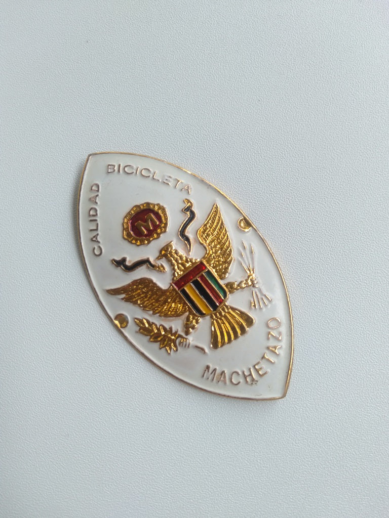 NOS MACHETAZO bicycle head badge with embossed aluminum left side view
