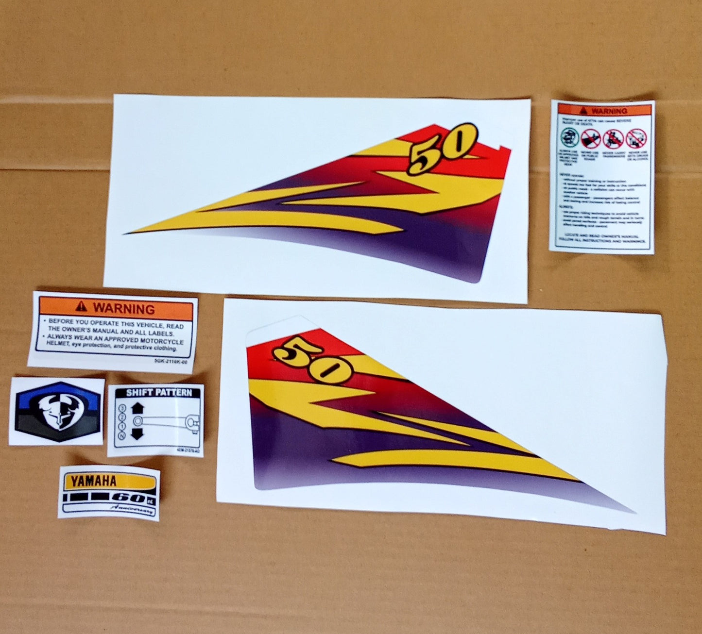 Set of decals Yamaha PW 50 with a prominent number 50 design on a cardboard background