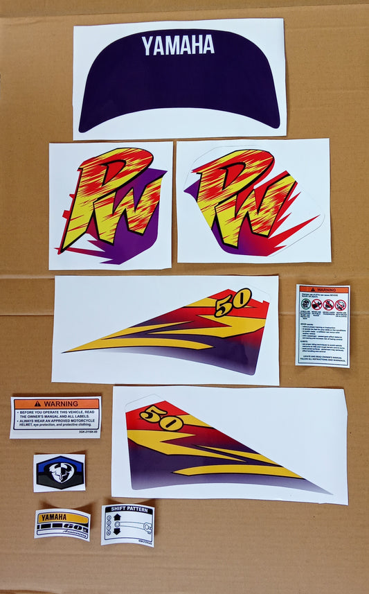 Collection of Yamaha decals and graphics on a cardboard background