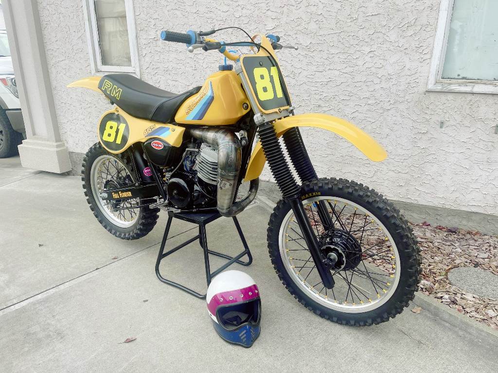 Yellow dirt bike with number 81 on a stand right front view