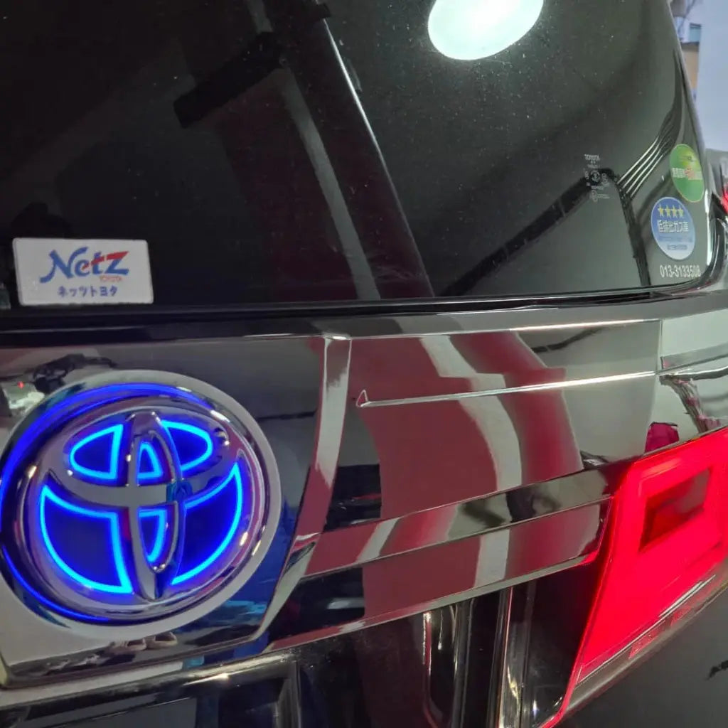 Nighttime glow perspective showing the cobalt blue illuminated Toyota LED rear emblem logo.