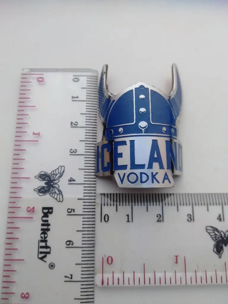 Measurement guide showing height and width dimensions of the handmade Iceland stainless emblem.