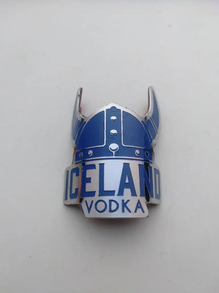 Close-up view of the detailed silver and blue enamel Viking helmet logo on the Iceland steel head badge.