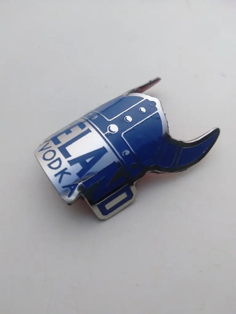Detail shot highlighting the crisp etched line art and blue paint infill on the Iceland reproduction bike badge.