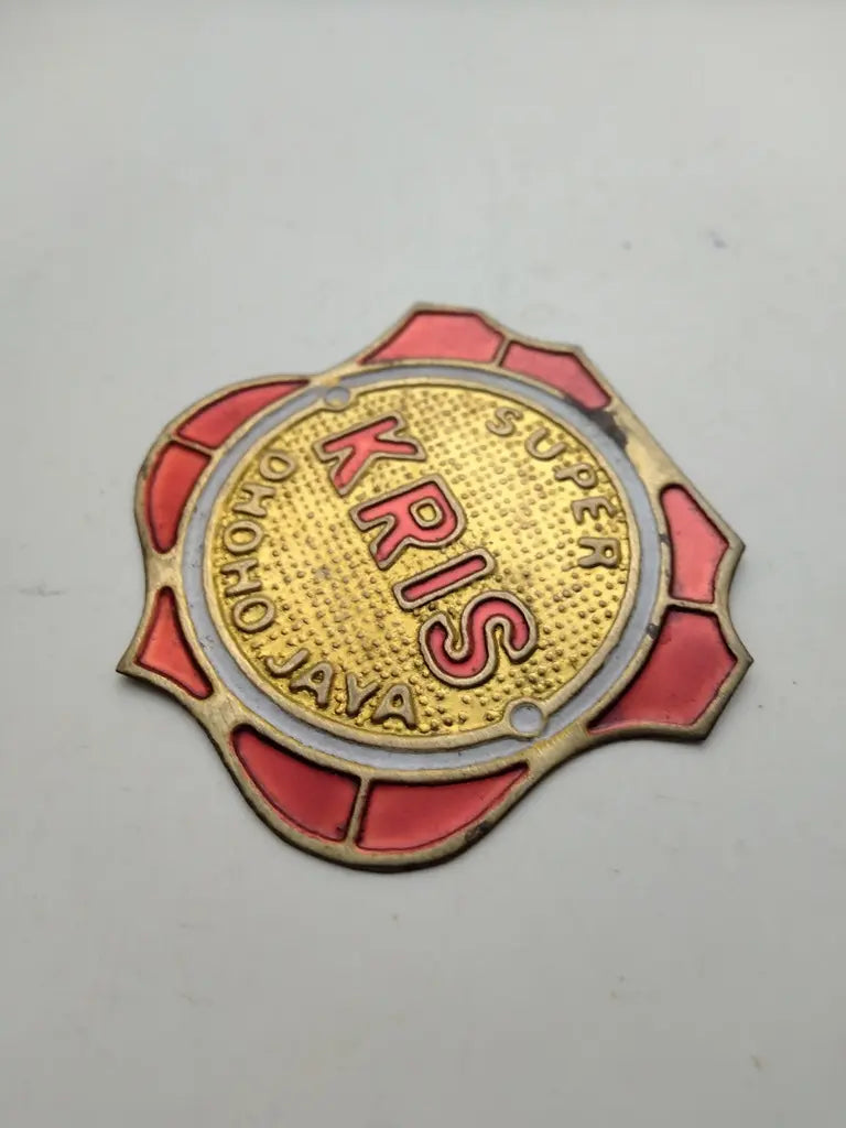 Embossed brass Kris bicycle emblem