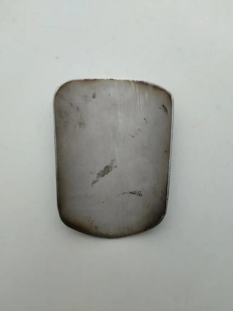 Rear view showing the clean bare metal surface on the back of the Marin bike badge.
