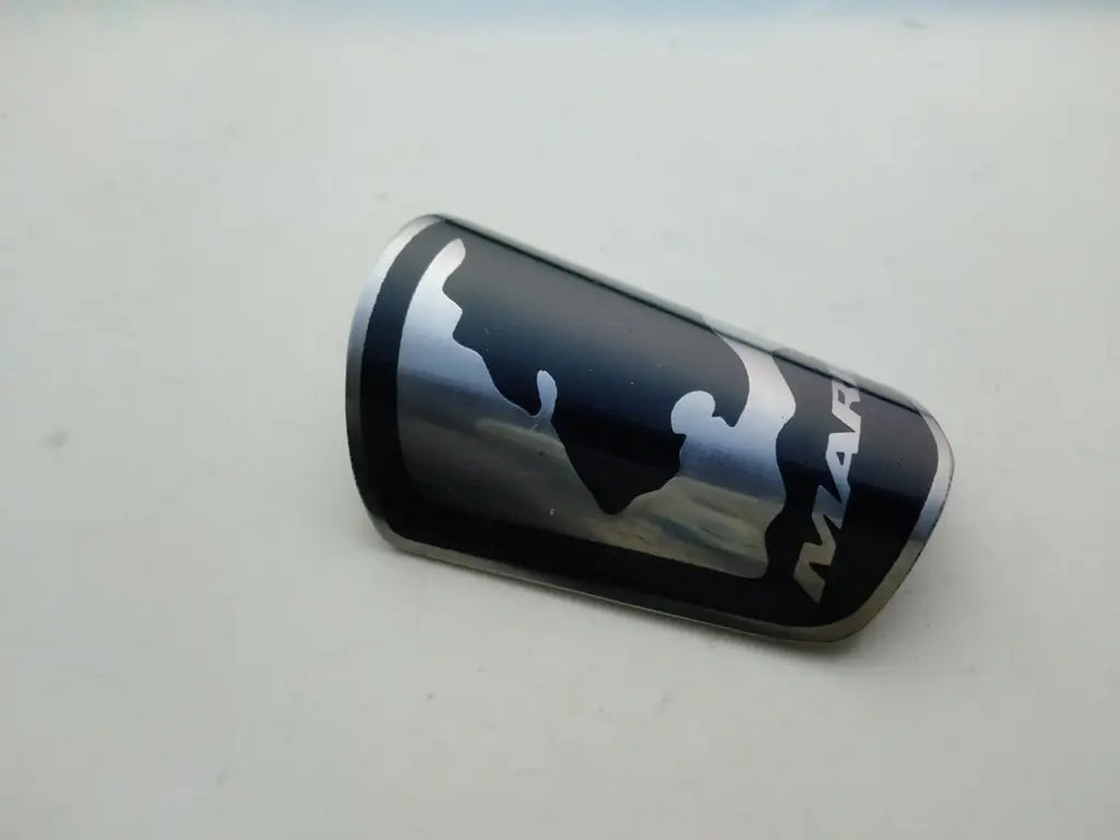 Close-up view of the detailed silver and black enamel logo on the Marin steel head badge.