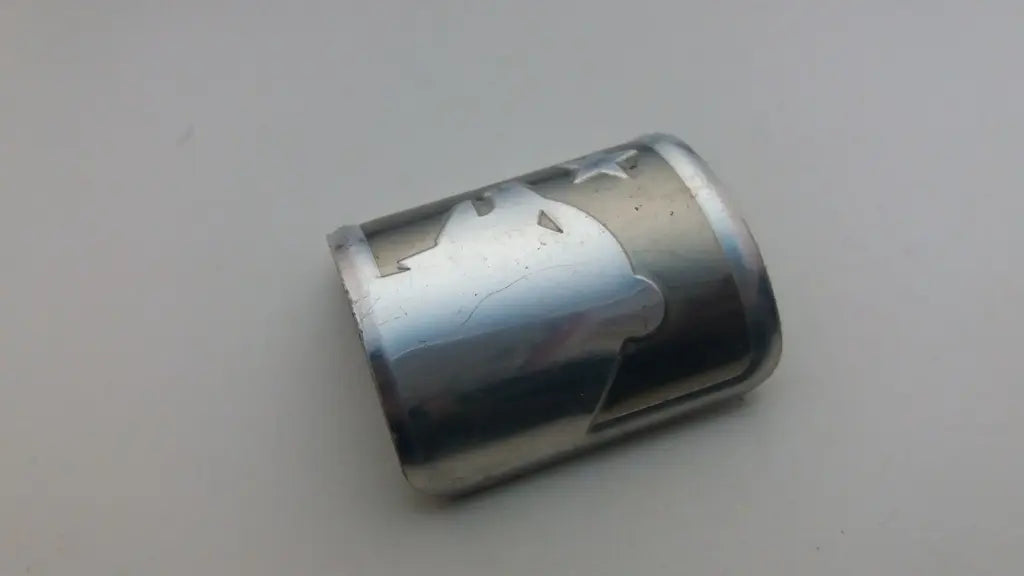 Side profile perspective showing the slim formable aluminum construction of the Marin emblem.