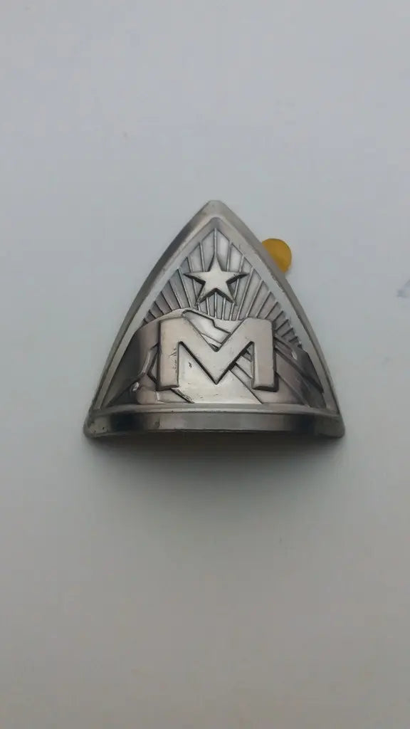 NOS Marin M logo and star silver triangle bicycle head badge emblem in embossed aluminum.