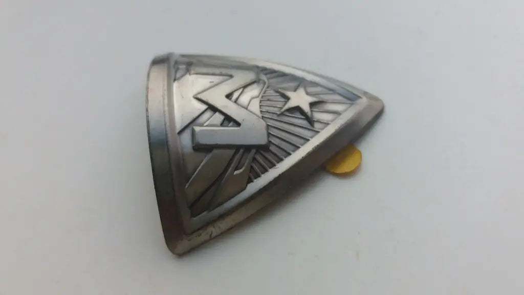 Side profile perspective showing the slim formable aluminum construction of the Marin emblem.