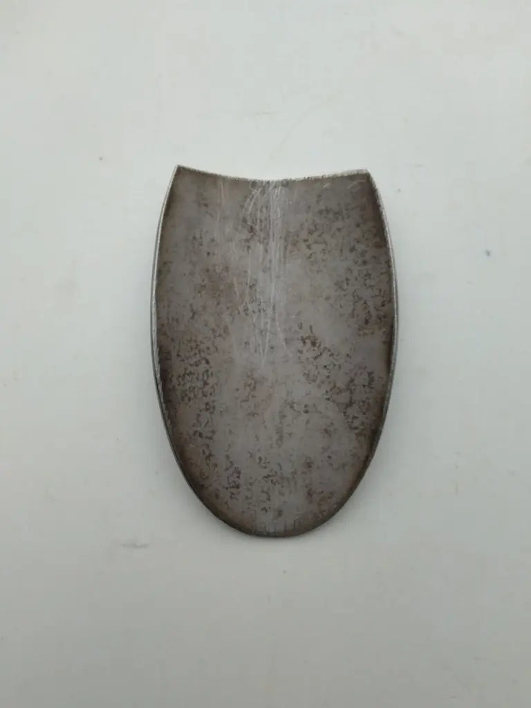 Rear view showing the clean bare metal surface on the back of the Ritchey bike badge.
