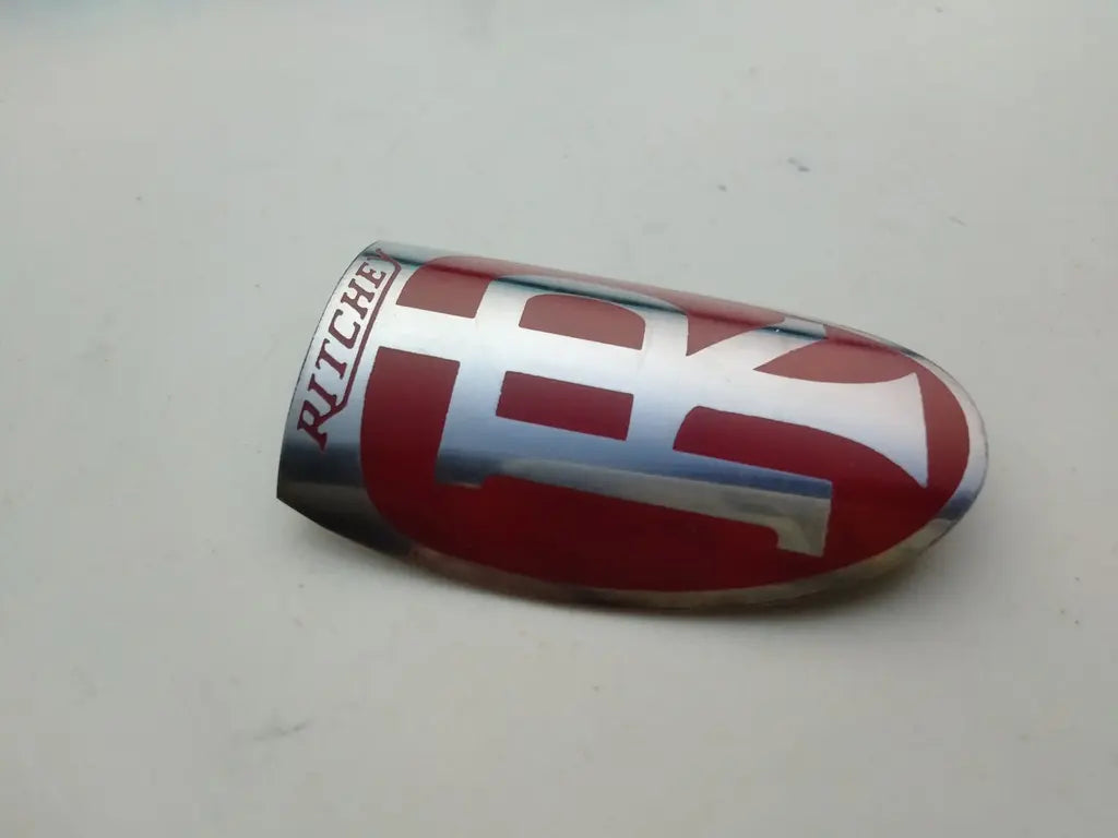 Close-up view of the detailed red, black, and silver enamel crest on the Ritchey steel head badge.