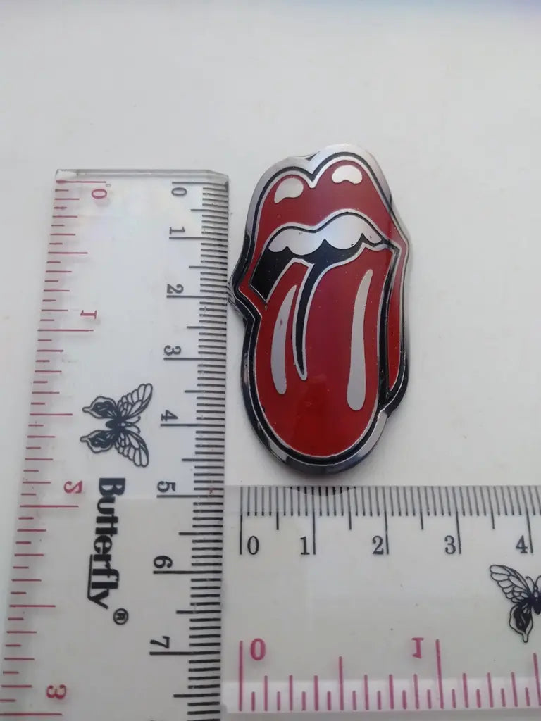 Measurement guide showing height and width dimensions of the handmade Rolling Stone stainless emblem.