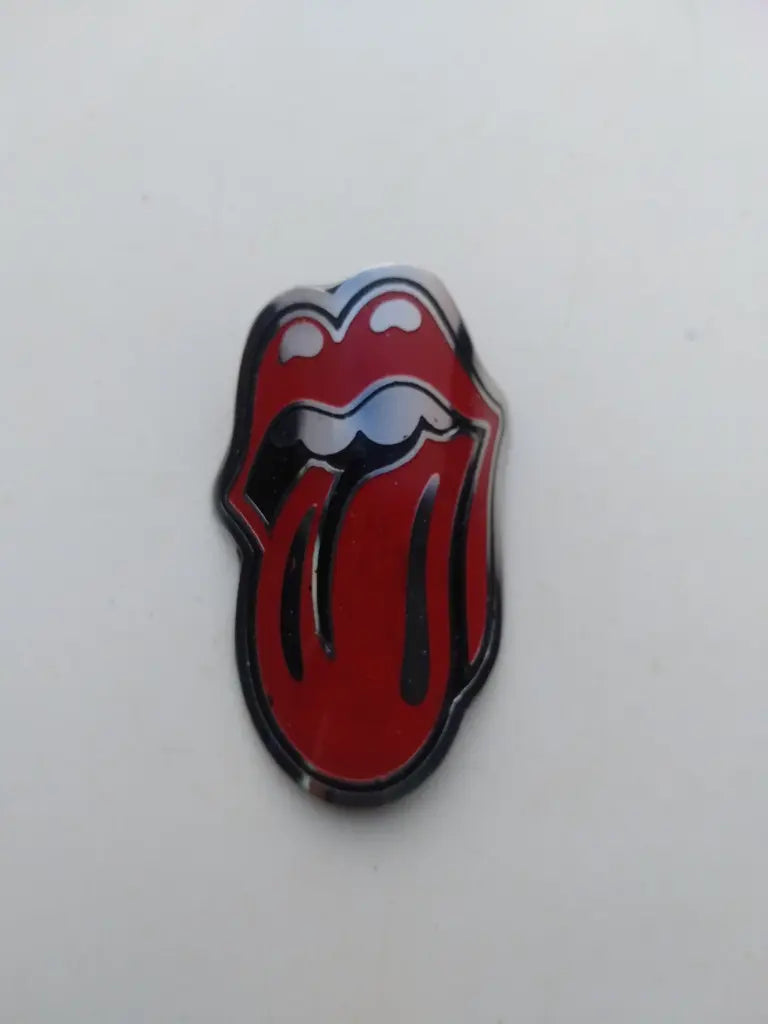 Close-up view of the detailed silver and red enamel tongue logo on the Rolling Stone steel head badge.
